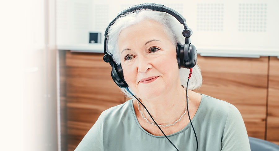 Frau mit Kopfhörern beim Hörtest bei Neuroth